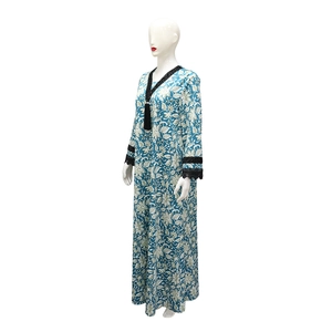 Detail of V-neckline with black fringe trim on a blue floral print maxi dress