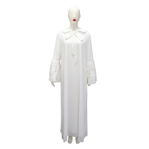 Detailed shot of white dress lace cuffs and intricate pleated sleeve embroidery