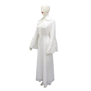 Detail of white maxi dress showing delicate lace cuffs and elegant pleated bell sleeves