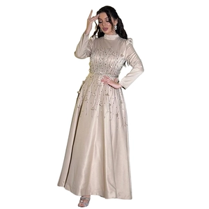 Detail of elegant champagne satin gown featuring intricate beadwork and sequin patterns