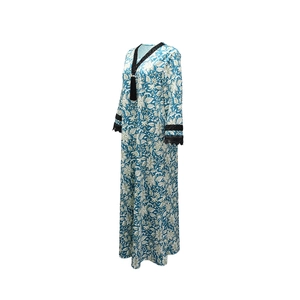 Close-up of V-neck print dress featuring black lace trim and elegant long tassel detail