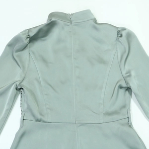 Detailed back view of a mint green satin evening dress featuring a high collar and zipper