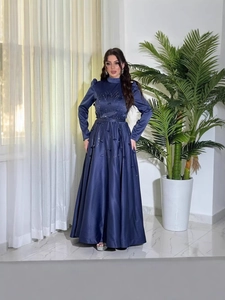 Elegant navy blue long sleeve evening gown with intricate sequins and floral appliques