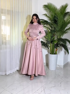 Pink long-sleeve evening gown with beaded embroidery and elegant satin finish
