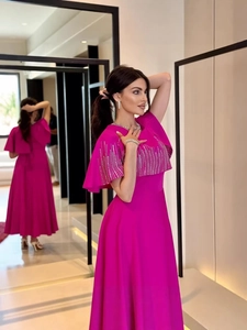 Elegante caftano fucsia sfiancato con decorazioni in strass e maniche stile mantella