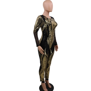 Detail of elegant gold sequin feather embroidery on black sheer long-sleeve jumpsuit