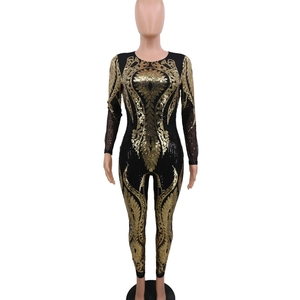 Close-up of gold sequins and retro embroidery on black long sleeve see-through bodysuit