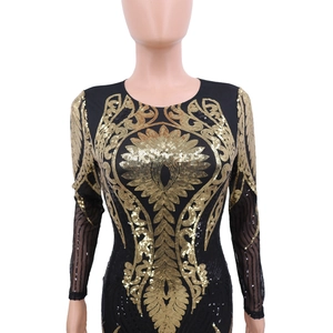 Detail of black long-sleeve dress featuring golden sequin vine and flower embroidery
