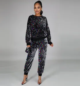 Detail of sequined fabric on a black long-sleeve top and matching joggers set
