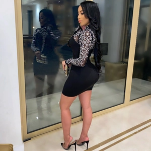 Chic black bodycon dress featuring mesh sleeves with rhinestone wave patterns