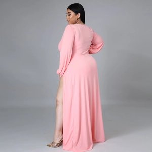 Detail view of pink long sleeve maxi dress featuring high slit and elegant draped fabric