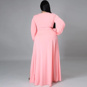 Back view of pink long-sleeved maxi dress with side slit and waist tie details