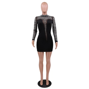 Detail of black party dress with sparkling rhinestones and sheer mesh patchwork inserts