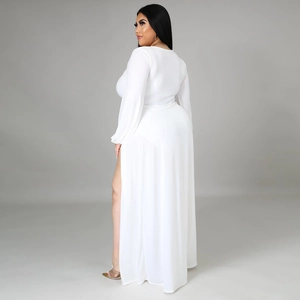 Detail view of the side-slit and elegant draping on this white long sleeve maxi dress