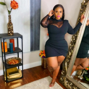 Slim fit black mini dress with long sleeves and mesh polka dot stitching on neckline