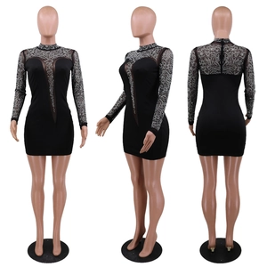 Detail of sheer mesh paneling and silver rhinestone embellishments on a black mini dress