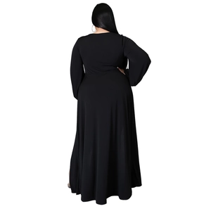 Rear view of plus size black maxi dress showing elegant draped skirt and full-length fit
