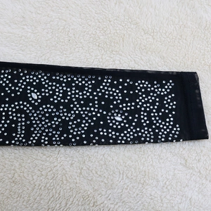 Detail of sheer black mesh sleeve with sparkling rhinestones on a fashion evening dress