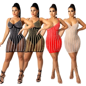 Detailed view of mini dresses with sheer mesh skirts and sparkling pearl embellishments