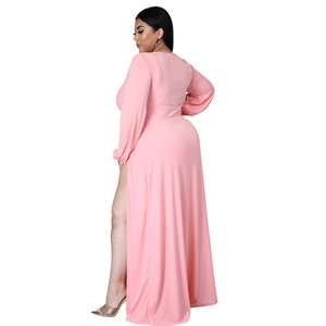 Detail view of pink long sleeve dress showing high side slit and soft draped fabric