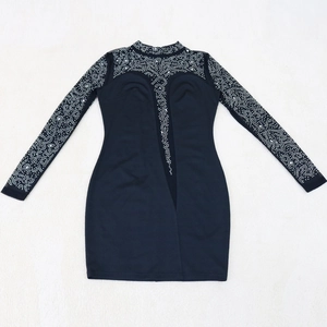 Detail of black evening dress featuring crystal rhinestones on sleeves and mesh V-neckline