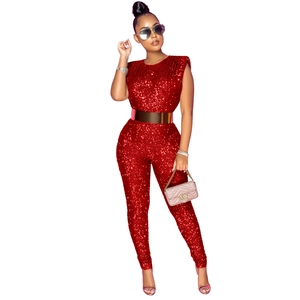 Detail of red sequined sleeveless jumpsuit with shiny gold belt for party styling