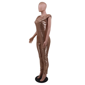 Detail of rose gold sequin jumpsuit showing shimmering metallic fabric for party wear