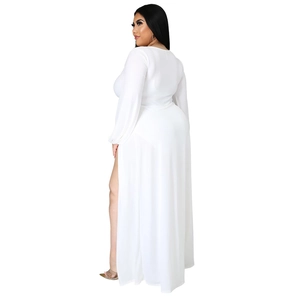 Detail of high side slit on elegant long sleeve white maxi dress with premium stretch fabric