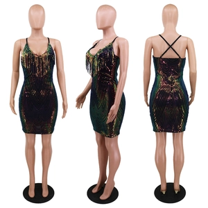 Macro view of sequin tassel detail on V-neck dress with adjustable crisscross back straps