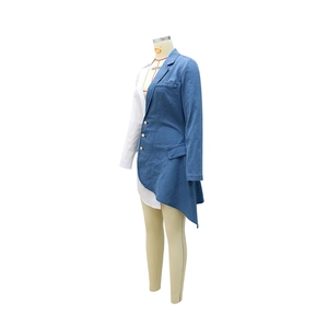 Detail of asymmetrical shirt dress with gold metal buttons and blue denim patchwork