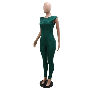 Close-up of high-density green sequin fabric on a sexy sleeveless jumpsuit for women
