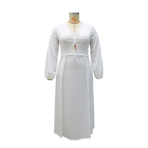Detail view of the deep V-neckline with drawstring ruching on the white long sleeve dress
