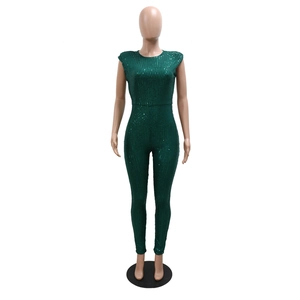 Detailed close-up of dark green sequin texture on a slim-fit sleeveless jumpsuit