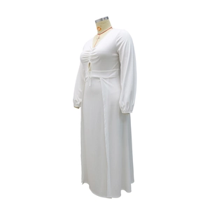 Close-up of V-neck white maxi dress with drawstring ruched detail and long sleeves
