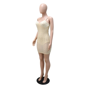 Detail view of mini dress showing intricate pearl beading and rhinestone embellishments