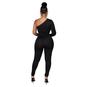 Rear view of a black one-shoulder tight jumpsuit with mesh details and long sleeve
