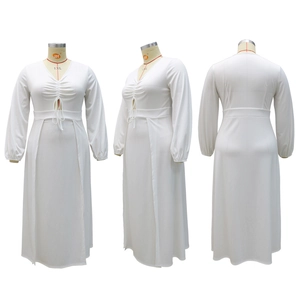 Detail view of white V-neck maxi dress featuring pleated bodice and waist tie detail