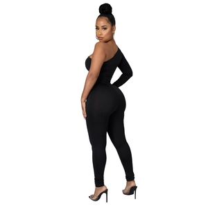 Detailed view of black asymmetric off-shoulder bodysuit with sheer mesh flocking texture