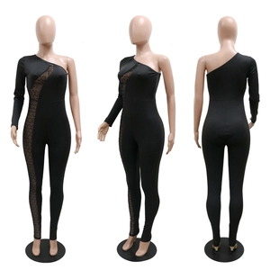 Detail of black one-shoulder jumpsuit with sheer mesh diagonal cut-out and rhinestones