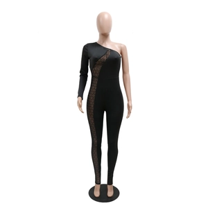 Detail of black one-shoulder jumpsuit featuring rhinestone mesh cutout accents and long sleeve