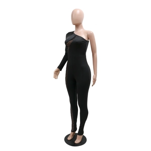 Detail of black asymmetrical jumpsuit with sheer mesh cut-outs and sparkling rhinestones