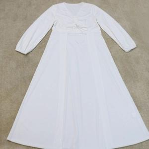 Detail of V-neckline with drawstring ruching on a white long-sleeve casual dress