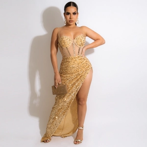 Detail of elegant gold sequined evening dress with high slit and sheer mesh embroidery