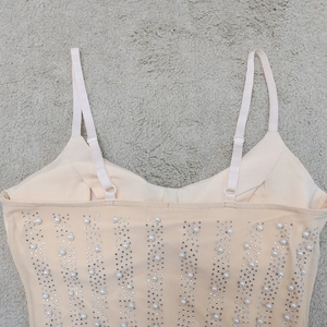 Detail of mesh mini dress with white pearls, rhinestones and adjustable straps