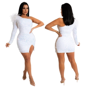 Detailed view of white sequined fabric with plush feather accents on a one-shoulder dress