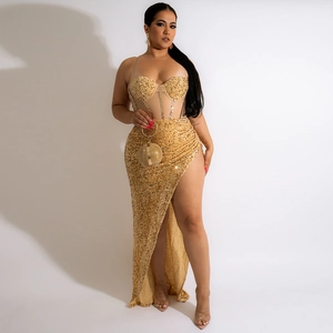 Detail of sequined corset top and high slit skirt on a gold two-piece evening dress