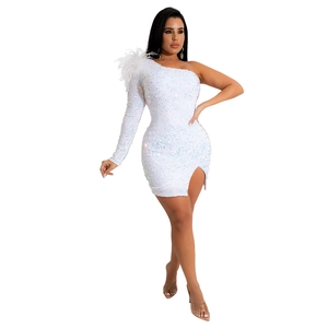 Detail of white sequin dress featuring ostrich feather shoulder and side slit