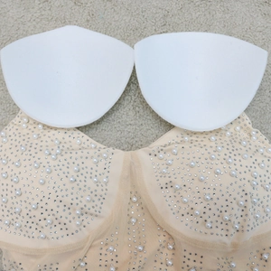 Detail of nude tube dress featuring white faux pearls and rhinestones with removable pads