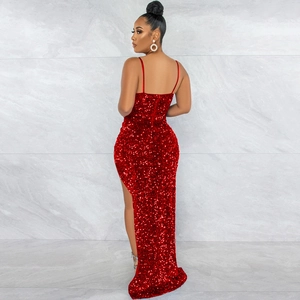 Detail of red sequin evening gown showing the high slit and shimmering fabric texture