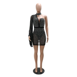Detail of black mesh mini dress with silver rhinestones and asymmetric sleeve design